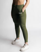 Left side view of green joggers showing contour fit and high-rise waistband. 