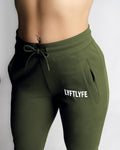 Elastic waistband and drawcord detail on LYFTLYFE green joggers. 
