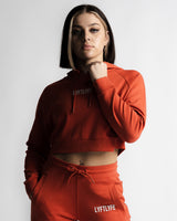 Cropped front view of LYFTLYFE React hoodie in cherry red showing logo and high-waist jogger pairing.