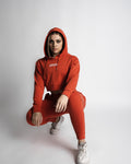 Relaxed pose in LYFTLYFE crop hoodie and jogger set in cherry red. 