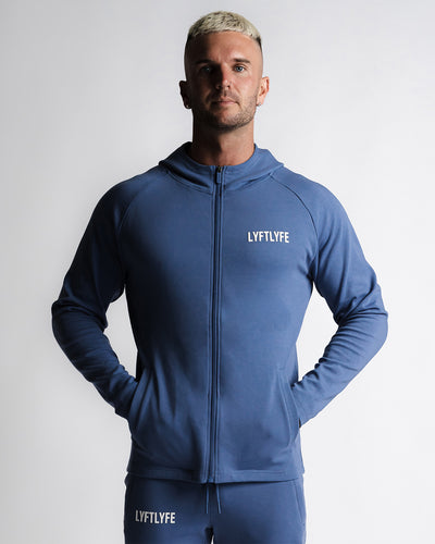 Men's blue zip-up hoodie with hood on and LYFTLYFE logo on chest.