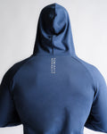 Close-up of “Dominate Adversity” slogan printed on blue hoodie back seam.