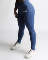 Left side angle of LYFTLYFE React joggers in blue showing tapered leg and pocket detail.