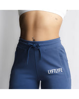 LYFTLYFE branding and front pocket detail on high-waisted joggers in blue.
