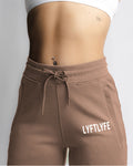 High-rise waistband of womens joggers in taupe, showing reinforced stitching and comfort. 