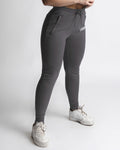 Right side view of women’s grey joggers  with high waist and white LYFTLYFE logo. 