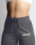 Close-up of Elastic waistband and drawcord detail on LYFTLYFE women's joggers in grey. 
