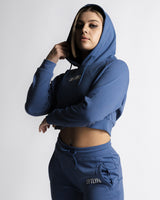 Right side profile of cropped LYFTLYFE hoodie in blue paired with React joggers.