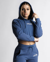 Left side profile of cropped LYFTLYFE hoodie in blue paired with React joggers.