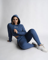 Woman sitting on floor wearing full LYFTLYFE React set in blue.