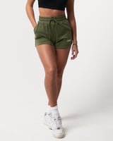 Front-facing view of women’s Balance Shorts in green with a soft cotton-polyester blend and side pockets for convenience.