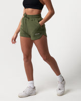 Side view of women’s Balance Shorts in green with a soft cotton-polyester blend and side pockets for convenience.