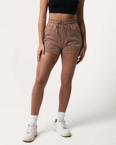Women’s lightweight taupe sweat shorts with a flattering high-waisted fit and tonal drawstring for size customization.