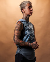 Women’s athletic sleeveless hoodie in blue camo, shown from the right side, showcasing a relaxed hood and moisture-wicking technology.