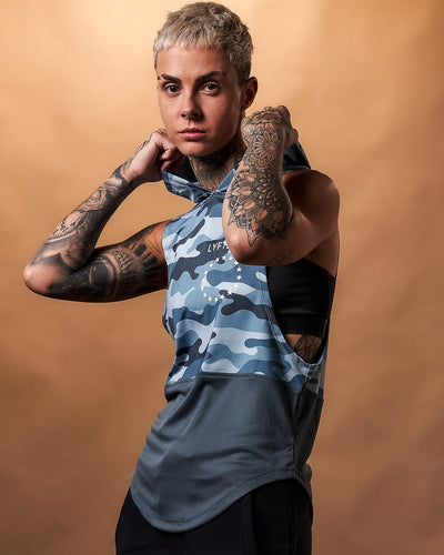 Blue camo sleeveless hoodie for women, featuring a white Lyftlyfe logo and a high-performance sweat-wicking fabric.