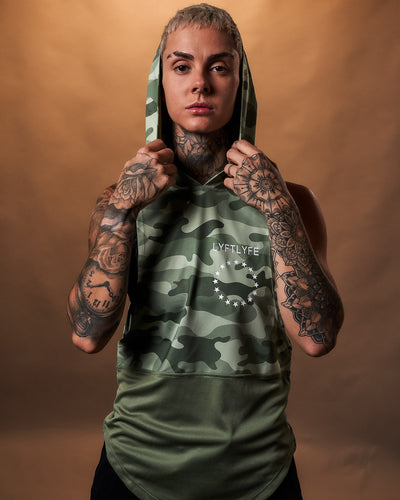 Green camouflage sleeveless hoodie on a light gray background