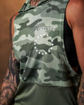 Close-up shot of the Lyftlyfe branding on the green camo sleeveless hoodie, designed for style and performance.