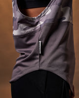 Close-up of the Dominate Adversity tag on the side hem of the Women’s Command Cut Sleeve in purple camo.