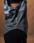 Detailed shot of the ‘Dominate Adversity’ flag tag on the side of the blue camo sleeveless shirt. 