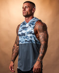 Men’s sleeveless gym hoodie in blue camo, displayed from the left side, highlighting its curved hem and durable triple-blend fabric.