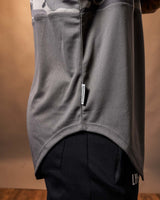 Detailed shot of the ‘Dominate Adversity’ flag tag on the side of the black camo sleeveless tank top.