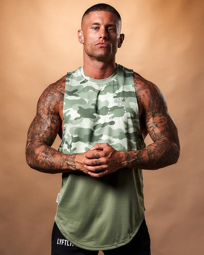 Green camouflage sleeveless shirt with a plain green bottom on a light gray background