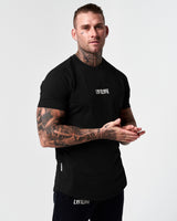 Men’s fitted t-shirt in black, shown from the right side, designed for comfort, movement, and moisture-wicking performance.