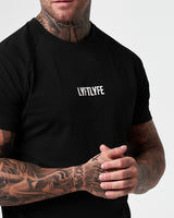Close-up of the white LYFTLYFE logo on the chest of the Contour Men’s T-Shirt in black, adding a premium touch.