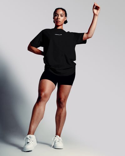 Women’s oversized Contour T-shirt in black, featuring a relaxed fit, moisture-wicking cotton blend, and a 3D rubberized Lyftlyfe logo.