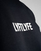 Close-up of the 3D rubberized LYFTLYFE logo on the chest of the Contour Men’s T-Shirt in black, adding a premium touch.