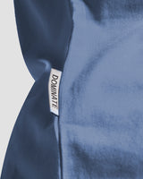 Detailed view of the LYFTLYFE side flag tag on the Contour Tee in blue, adding a signature touch to the women's t-shirt.