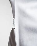Close-up of the Dominate Adversity tag on the Contour Tee in white, highlighting premium craftsmanship and branding.