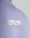 Close-up of the 3D rubberized LYFTLYFE logo on the chest of the Contour Men’s T-Shirt in purple, adding a premium touch.
