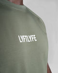 Close-up of the 3D rubberized LYFTLYFE logo on the chest of the Contour Men’s T-Shirt in green, adding a premium touch.