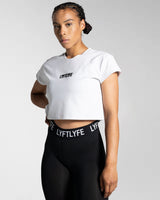 Fitted Drill Women’s Tee in white, shown from the left side, featuring advanced cotton blend fabric and a stylish cropped design.