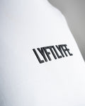 Close-up of the black Lyftlyfe logo on the white Contour Women’s Oversized Tee, crafted with precision and high-quality materials.