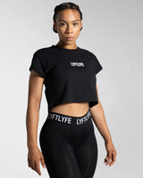 Right side view of the black Drill Women’s Crop T-shirt, showcasing its fitted cut, soft-stretch fabric, and moisture-wicking properties.