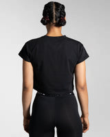 Drill Women’s Crop T-shirt in black, displayed from the back, showcasing its fitted cut, soft-stretch fabric, and moisture-wicking properties.