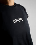 Close-up of the Lyftlyfe 3D rubberized logo on the chest of the black Drill Women’s Crop Tee, showcasing premium branding.