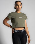 Fitted Drill Women’s Tee in olive green shown from the right side, featuring advanced cotton blend fabric and a stylish cropped design.