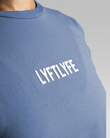 Close-up of Lyftlyfe’s textured 3D logo on the Contour Oversized Tee in blue, designed for a premium aesthetic.