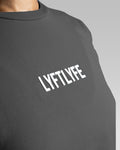 Close-up of Lyftlyfe’s textured 3D logo on the Contour Oversized Tee in dark grey, designed for a premium aesthetic.