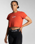 Left side angle of the red Drill Women’s Crop Tee, designed for unrestricted movement with a cooling and second-skin feel.