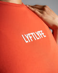 Close-up of the Lyftlyfe logo on the Contour Women’s Oversized Tee in red, crafted with precision and high-quality materials. 