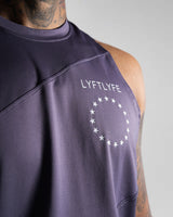 Close-up of white Lyftlyfe logo on left chest of Men’s Dominance Cut Sleeve tank in purple.