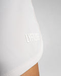 3D rubberized LYFTLYFE logo close-up on light pink athletic shorts.