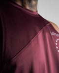 Close-up of reinforced seams and stretchable tri-blend fabric on sleeveless tank top in dark wine color. 