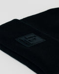 Zoomed-in detail of black LL patch on black LYFTLYFE beanie.