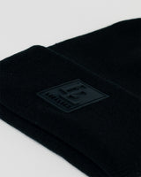 Zoomed-in detail of black LL patch on black LYFTLYFE beanie.