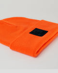 LYFTLYFE papaya orange toque laid flat with front-facing black rubberized patch.